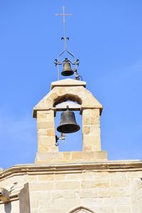 Low angle view of bell tower against sky