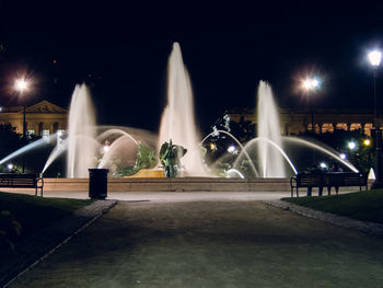 Fountain against sky at night