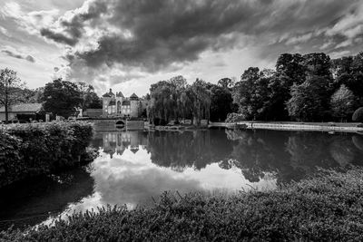 Reflection of trees in lake against sky