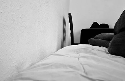 Empty bed against wall at home