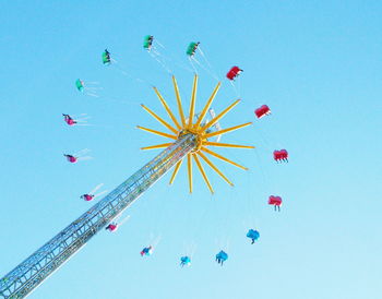 Low angle view of ferris wheel against blue sky