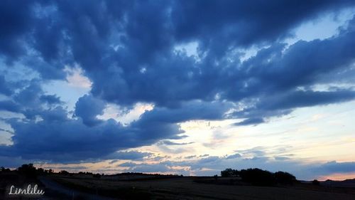 Scenic view of landscape against cloudy sky