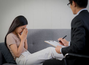 Young couple sitting on mobile phone