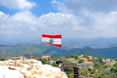 Lebanese flag over city against mountains