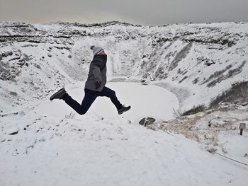 Full length of person walking on snow covered land