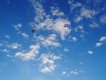 Low angle view of airplane flying against sky