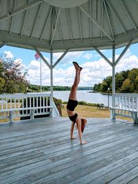 Woman doing handstand in gazebo