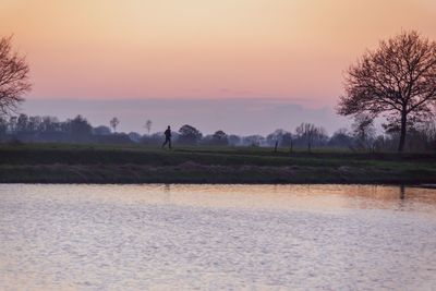 Scenic view of field against sky during sunset