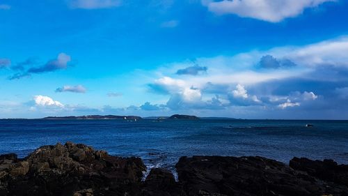 Scenic view of sea against blue sky