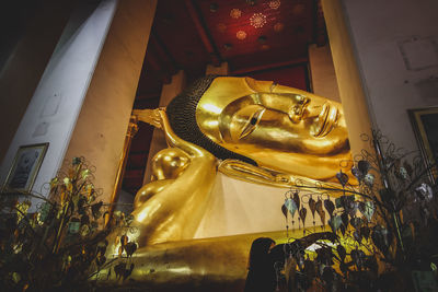 Statue of buddha against building