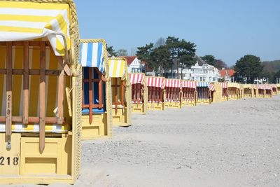 View of beach huts against clear sky