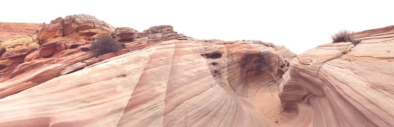 Low angle view of rock formations against sky