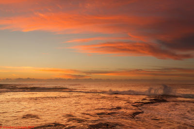 Scenic view of sea against orange sky