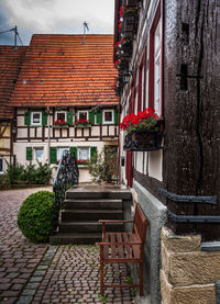 Potted plants on footpath against building