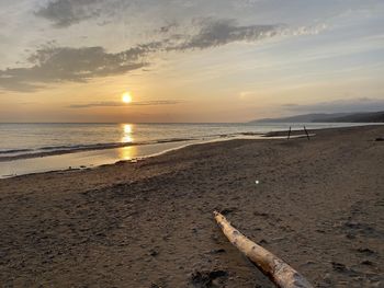 Scenic view of beach against sky during sunset