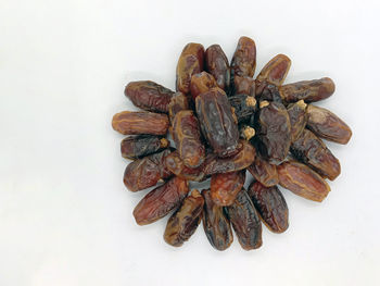 High angle view of roasted coffee beans against white background