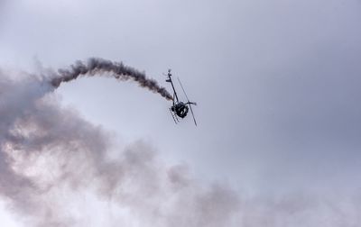 Low angle view of a helicopter  flying in sky