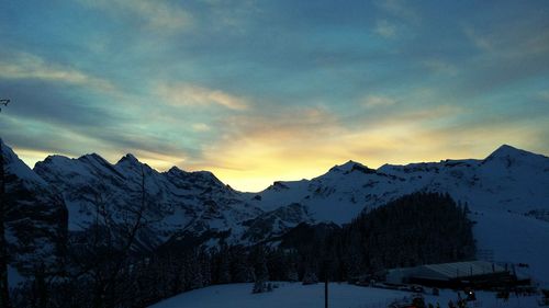 Scenic view of snow covered mountains against sky