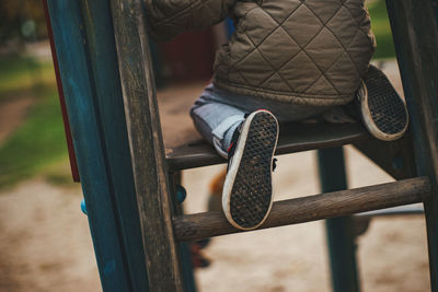 Child playing at park with muddy shoe