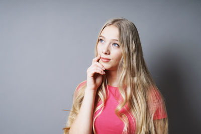 Portrait of a beautiful young woman over white background