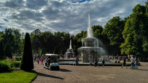 People in park against cloudy sky