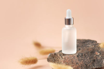 Close-up of beauty products against pink background
