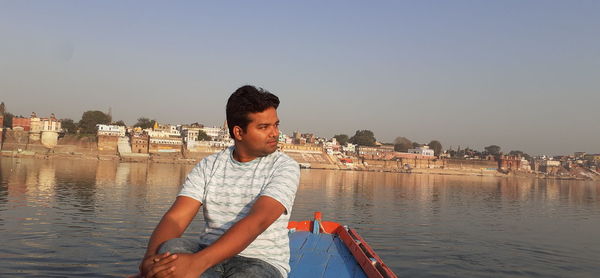 Man on boat against clear sky