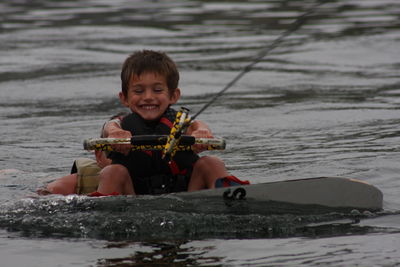 Portrait of happy boy surfing