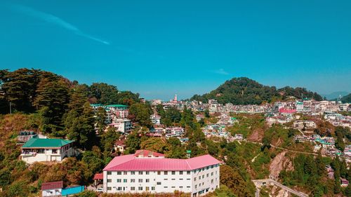 High angle view of townscape against blue sky