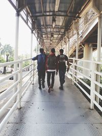 Rear view of people walking in corridor