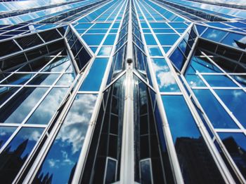 Low angle view of modern building against blue sky