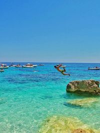 Scenic view of sea against clear blue sky
