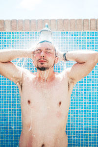 Full length of shirtless man in swimming pool