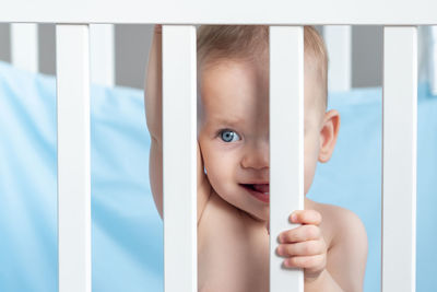 High angle view of baby boy lying on bed