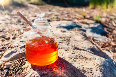 Close-up of drink in glass jar on land