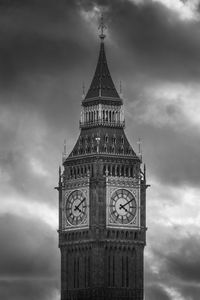 Low angle view of clock tower against cloudy sky