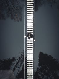 Directly above shot of woman walking on footbridge over river