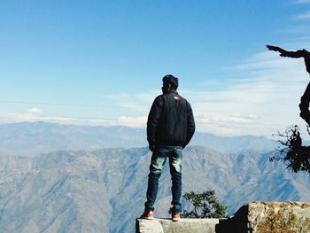 Man standing on mountain against sky