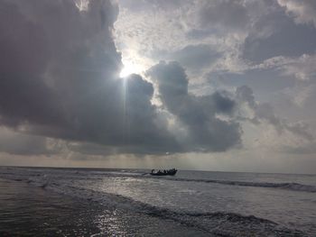 View of calm sea against cloudy sky