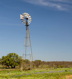 Low angle view of windmill against sky