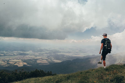 Blonde athlete poses on top of the mala fatra mountain. climbing mount hromova. a hiker walks along 