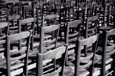 Empty chairs and tables in row