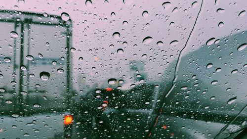 Full frame shot of wet glass window of car in rainy season
