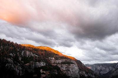 Low angle view of storm clouds over mountain