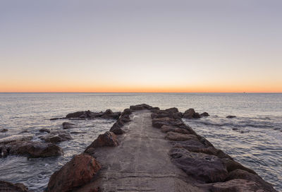 Scenic view of sea against clear sky during sunset