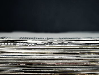 Close-up of stack of table against black background