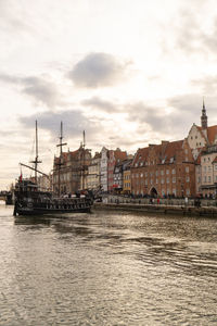 Beautiful old town of gdansk over motlawa river vintage ship pirate caravels sailing on motlawa