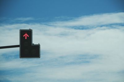 Low angle view of road sign against sky