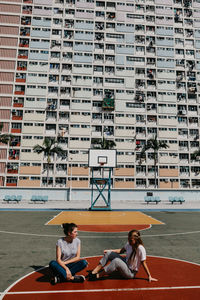 People sitting on floor in city