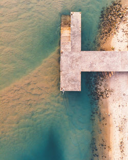 High angle view of text on wall by sea